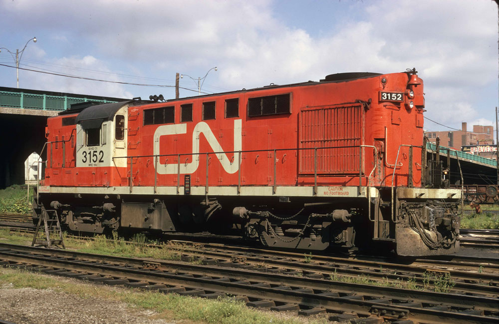 red locomotive with white cab and large white CN logo