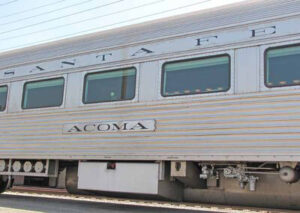 Close up of part of stainless steel car showing 'Acoma' nameplate.