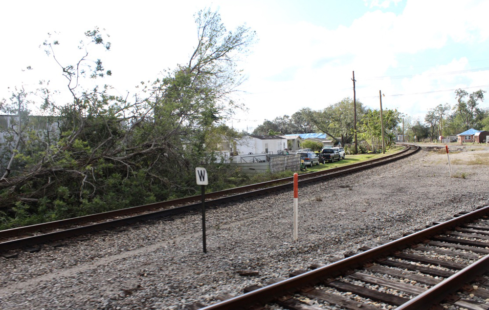 Railroad track curving away from main line in foreground