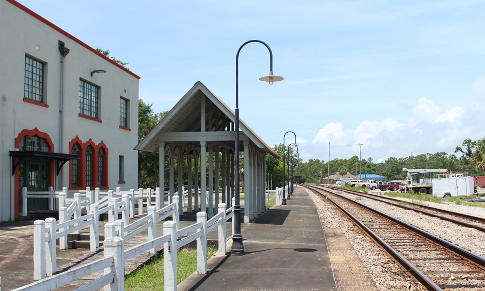 Station platform with covered waiting area