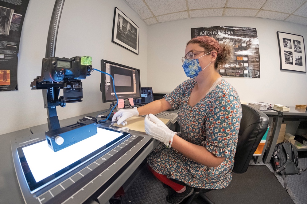 Woman working with camera on stand