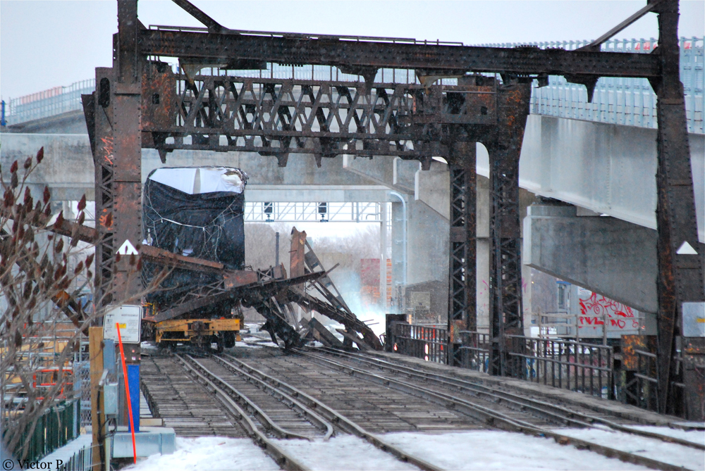 Railcar against twisted metal on bridge