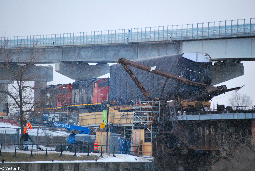 Ground-level view of train accident at elevated location