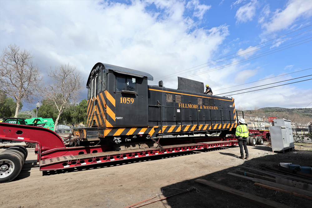 Locomotive without trucks on low-boy trailer