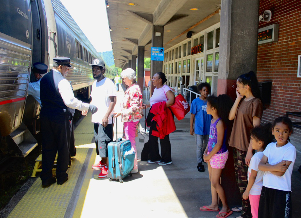 People boarding train at station