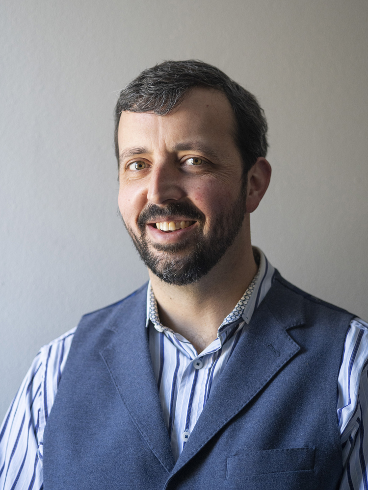 Head shot of man in shirt and vest