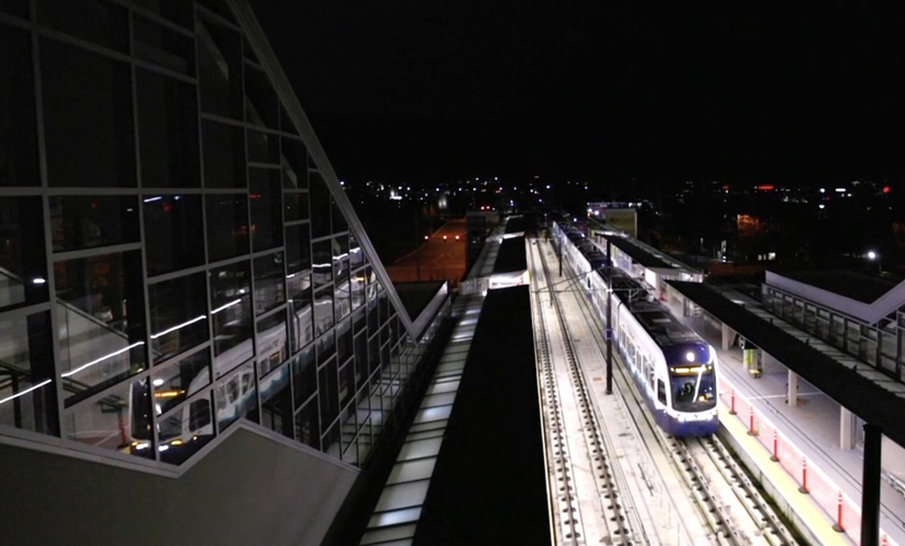 Light rail train enters station at night