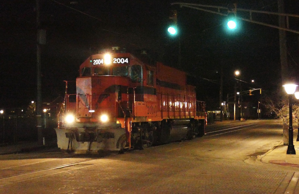 Orange diesel running light down street at night