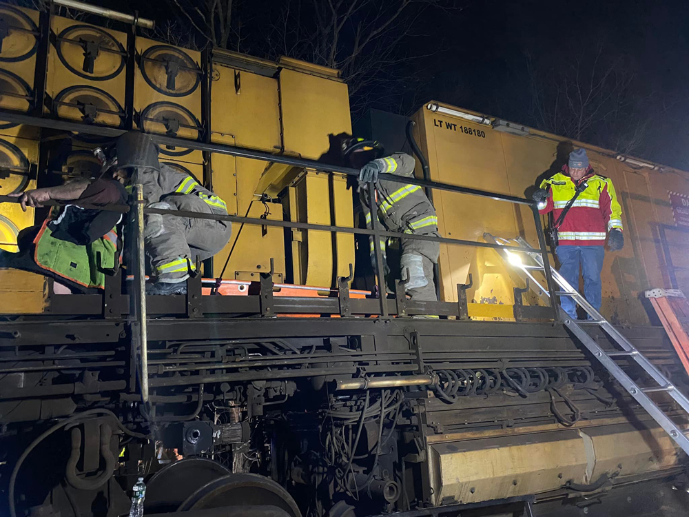 Firefighters and rail workers on maintenance machinery