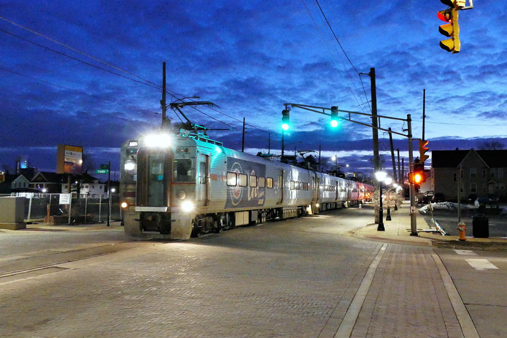 Commuter train of EMU equipment runs in street before dawn