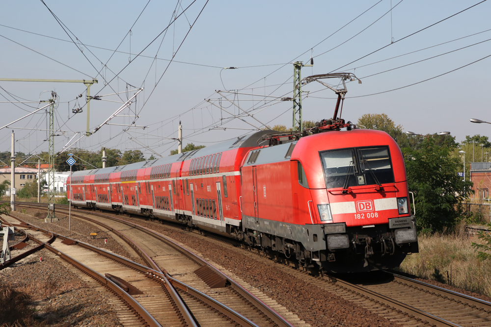Red German passenger train with electric locomotive and bilevel cars