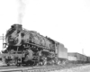Steam locomotive on freight train in black and white