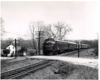 Conrail passenger trains: Streamlined locomotives lead a passenger train through the countryside.