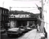 Conrail passenger trains: A rail diesel car runs on a bridge in a neighborhood.