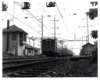 Conrail passenger trains: Electric multiple units under catenary stop at a station.