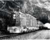 Conrail passenger trains: A streamline electric locomotive hauls a passenger train through a stone tunnel.