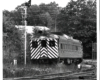 Conrail passenger trains: Stipped rail diesel car next to semaphore signal.