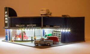 Menards O gauge Valley Motors building, lighted view