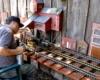 Man maintaining model live-steam engine.