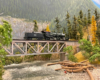 A Great Northern 2-6-6-2 steam locomotive crosses a steel deck truss bridge over a creek in wooded mountains.