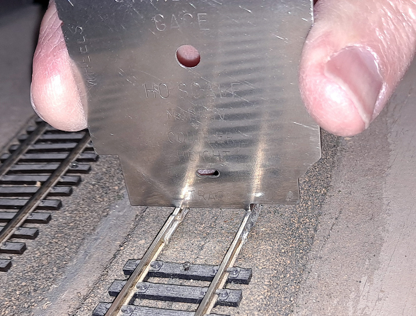 How to use PCB ties: A National Model Railroad Association standards gauge is placed on the track.