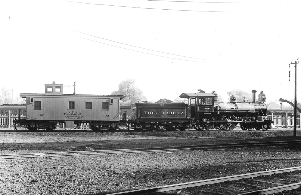 An HO scale scene of tank cars spotted at a loading rack, with storage tanks and an oil well nearby