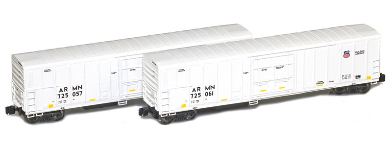 Photo of two mechanical refrigerator cars with exterior posts painted white with black, blue, yellow, and red graphics. 