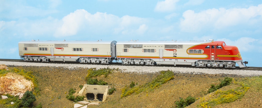 Photo of HO scale streamlined E1A and E1B diesel locomotives painted red and silver on scenicked base.
