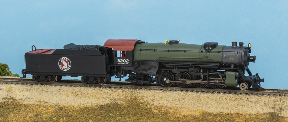 Photo of N scale 2-8-2 heavy Mikado steam locomotive painted black with Glacier Green boiler, mineral red cab roof, and gunmetal smokebox.