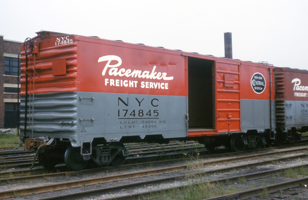 A red-and-gray New York Central boxcar labeled “Pacemaker Freight Service.”