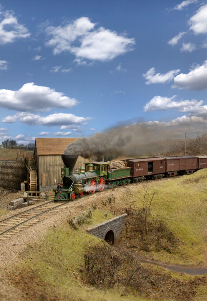 Model steam locomotive with plume of steam on a layout