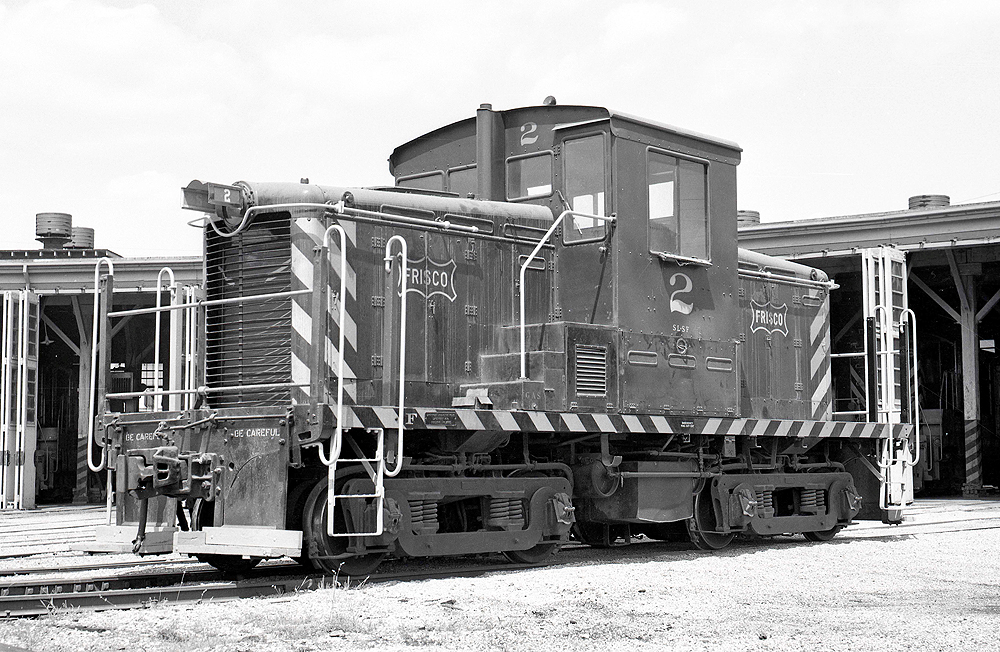 A black and white image of a center cab locomotive.