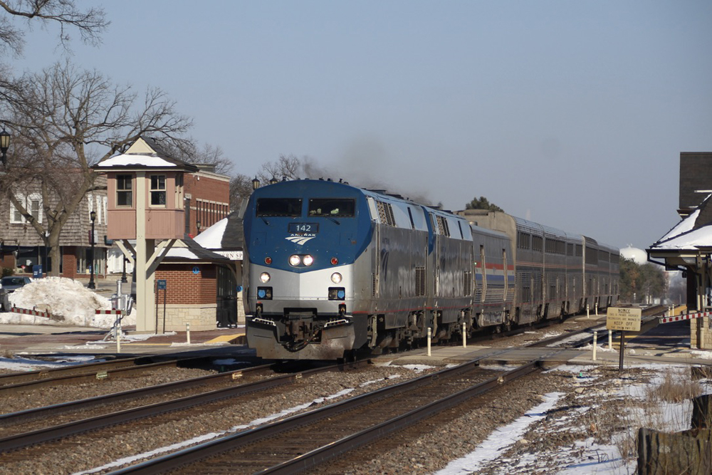 Passenger train passes commuter-train station