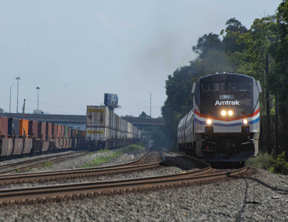 Passenger train on track at edge of yard