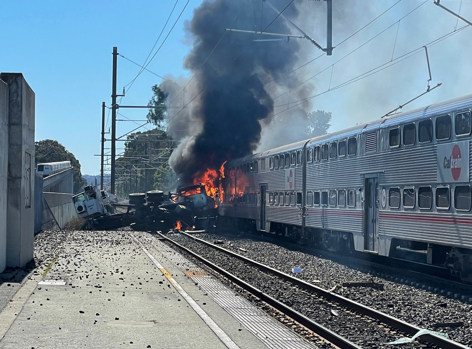 Train on fire with plume of black smoke