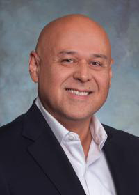 Smiling man in white shirt and blue coat