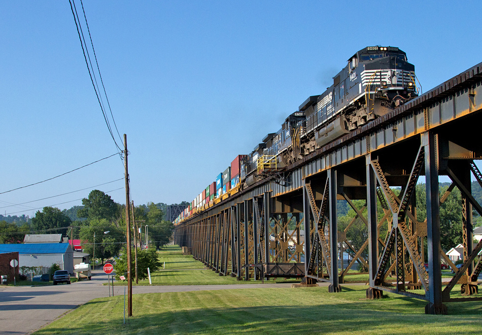 Train of containers on high bridge