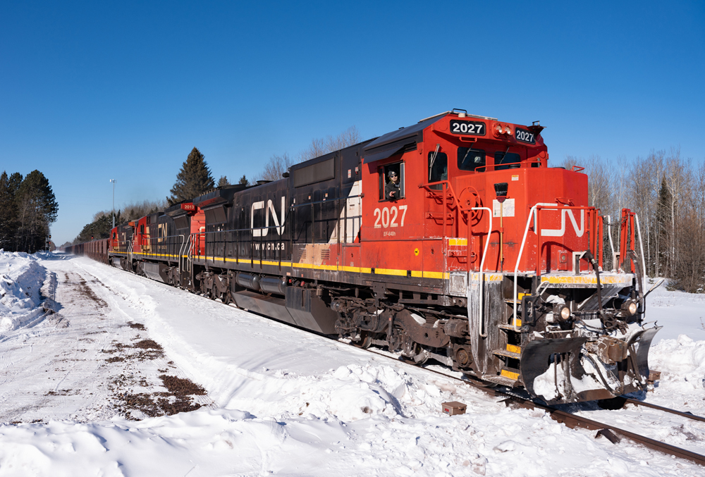Endangered Class I locomotives: Red and black locomotives in a snowy landscape.