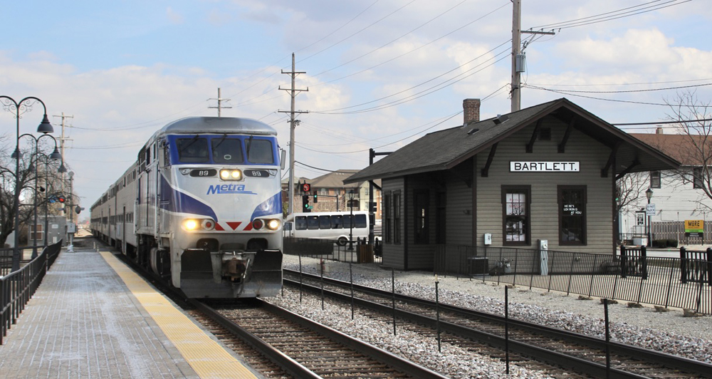 Passenger train passing wooden passenger station