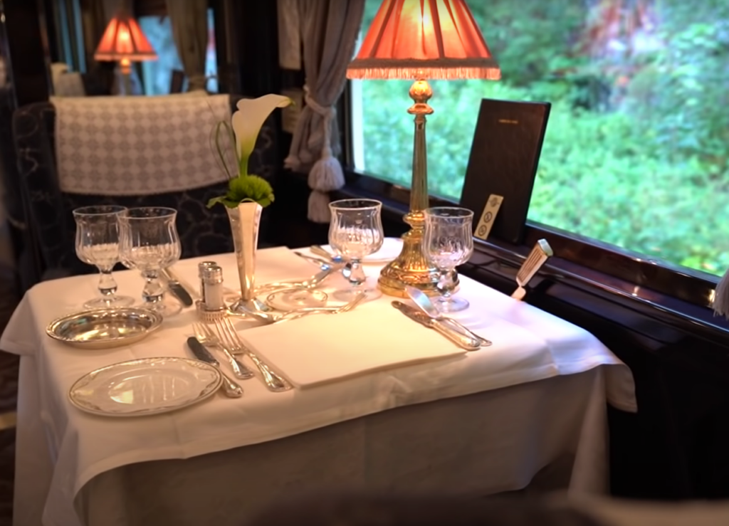 Venice Simplon Orient Express journey: A dining room table in a luxurious rail car.