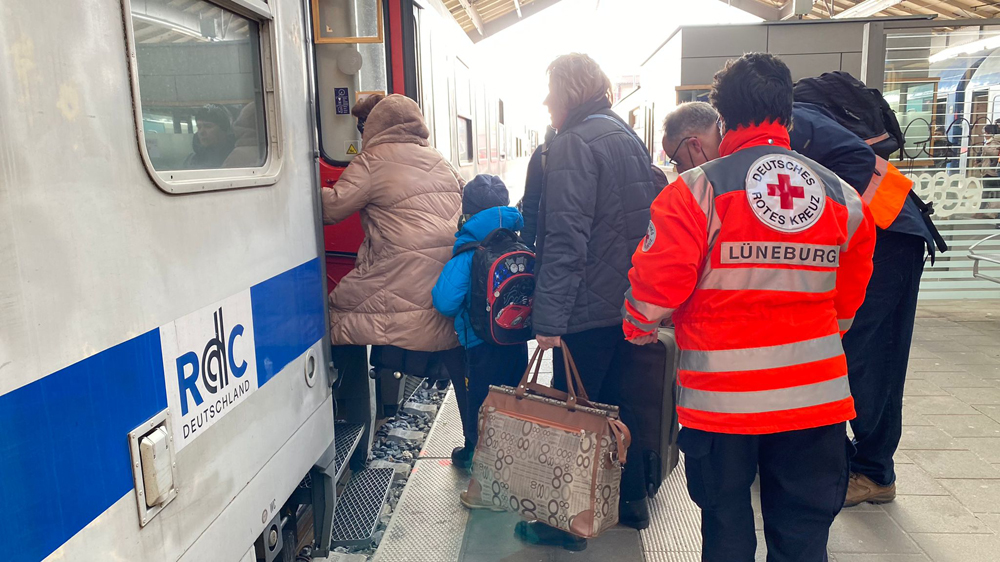 People being helped onto train