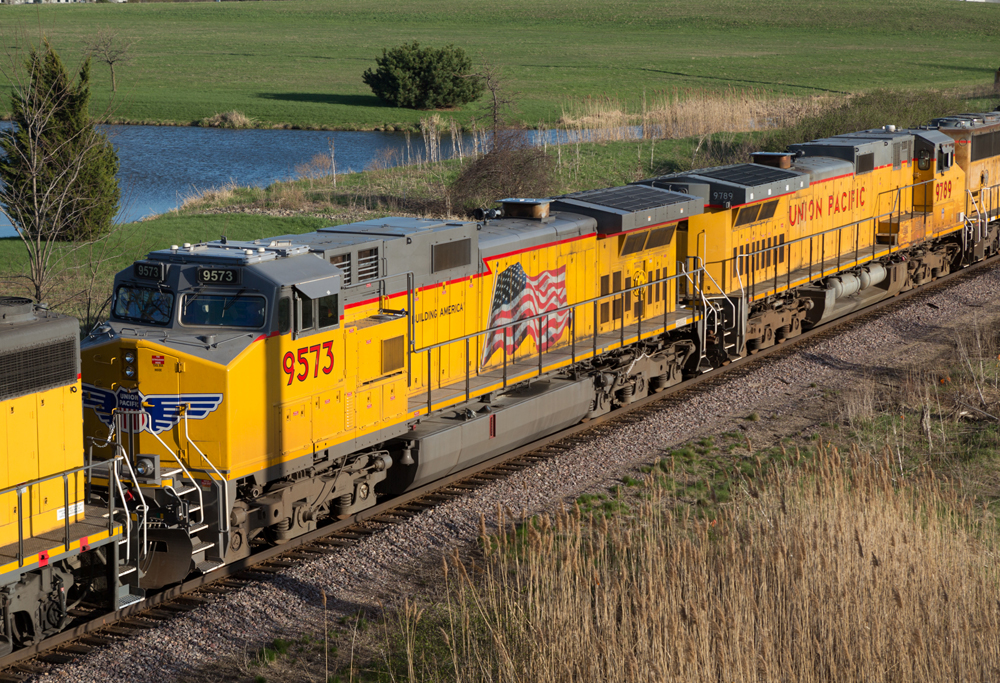 Yellow diesel locomotives parked together in a line.