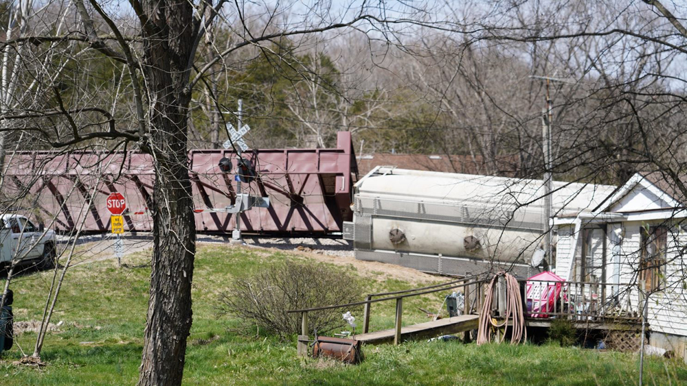 Overturned railroad cars near house