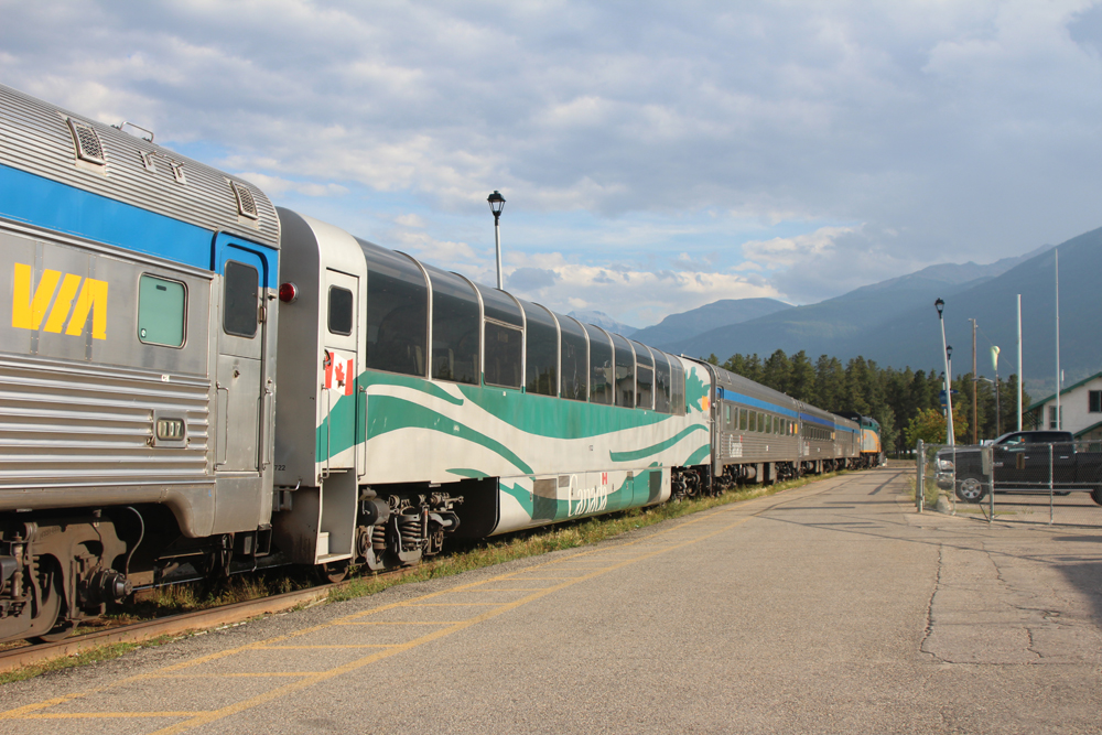 Car with large curving windows and white and teal paint scheme