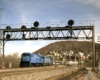 Conrail locomotives under signal bridge on curve