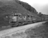 Diesel locomotives with coal train in treeless cut