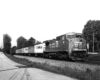 Diesel locomotive with trailers under signal bridge