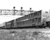 Slat-sided livestock cars behind diesel locomotive