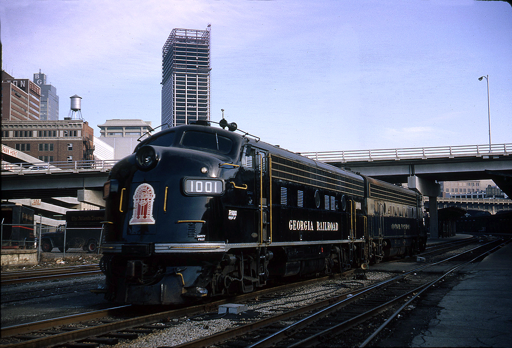 Diesel locomotive single order units: Black streamline diesel locomotive in a city scene.