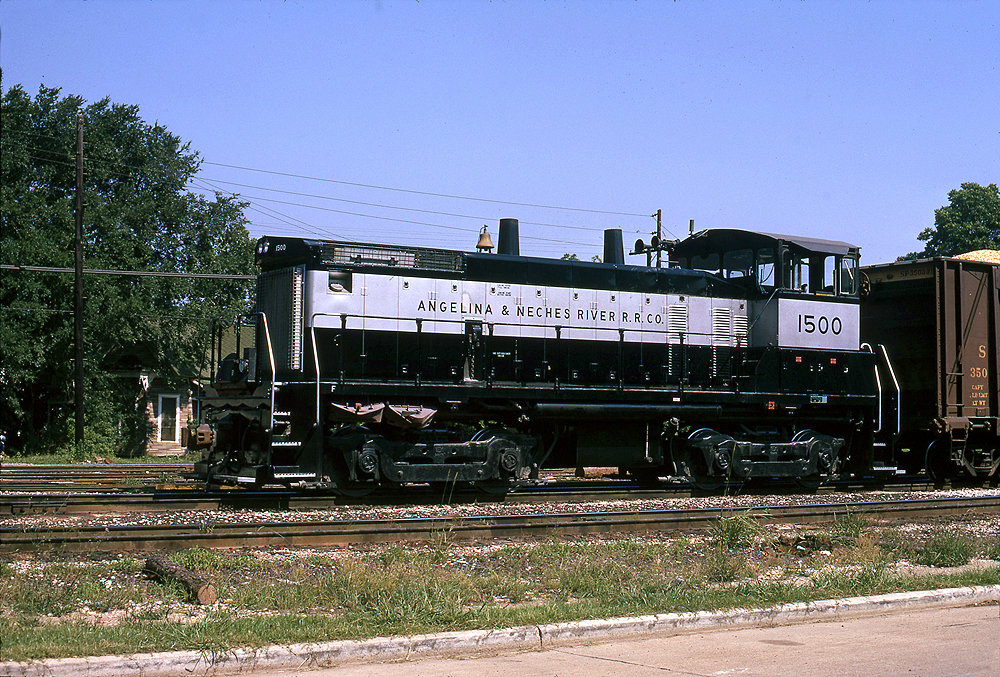 Black and purple locomotive on a freight train.